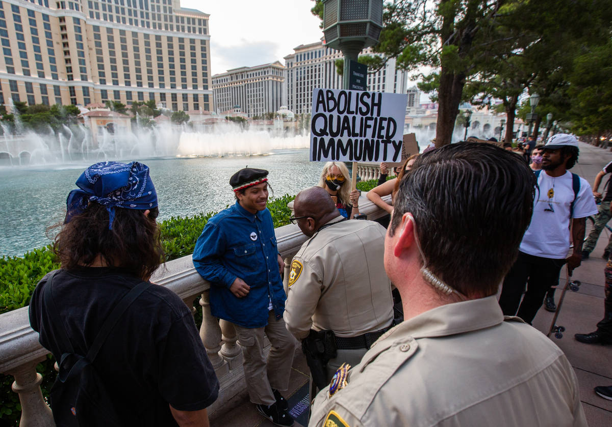 Porfirio Flores, a Black Lives Matter protester, speaks with Las Vegas police officers in front ...