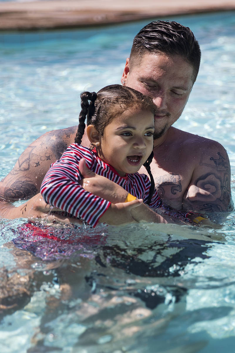 Terry Sharp plays with Zarah Mitchell, 3, at Garside Pool in Las Vegas, Monday, June 15, 2020. ...
