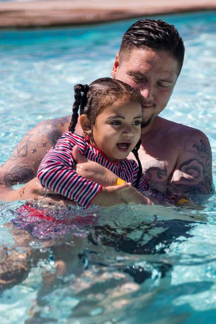 Terry Sharp plays with Zarah Mitchell, 3, at Garside Pool in Las Vegas, Monday, June 15, 2020. ...