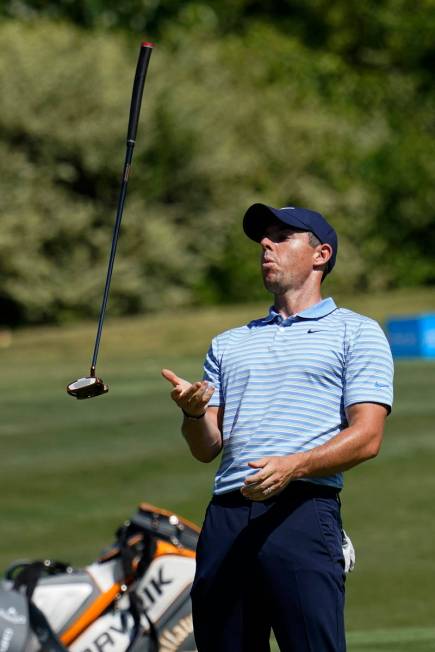 Rory McIlroy, of Northern Ireland, flips his putter after missing a birdie putt on the 15th gre ...