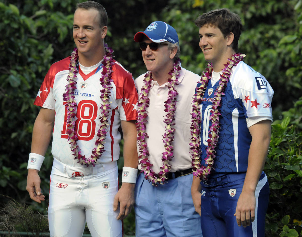 Indianapolis Colts quarterback Peyton Manning, left, and New York Giants quarterback Eli Mannin ...