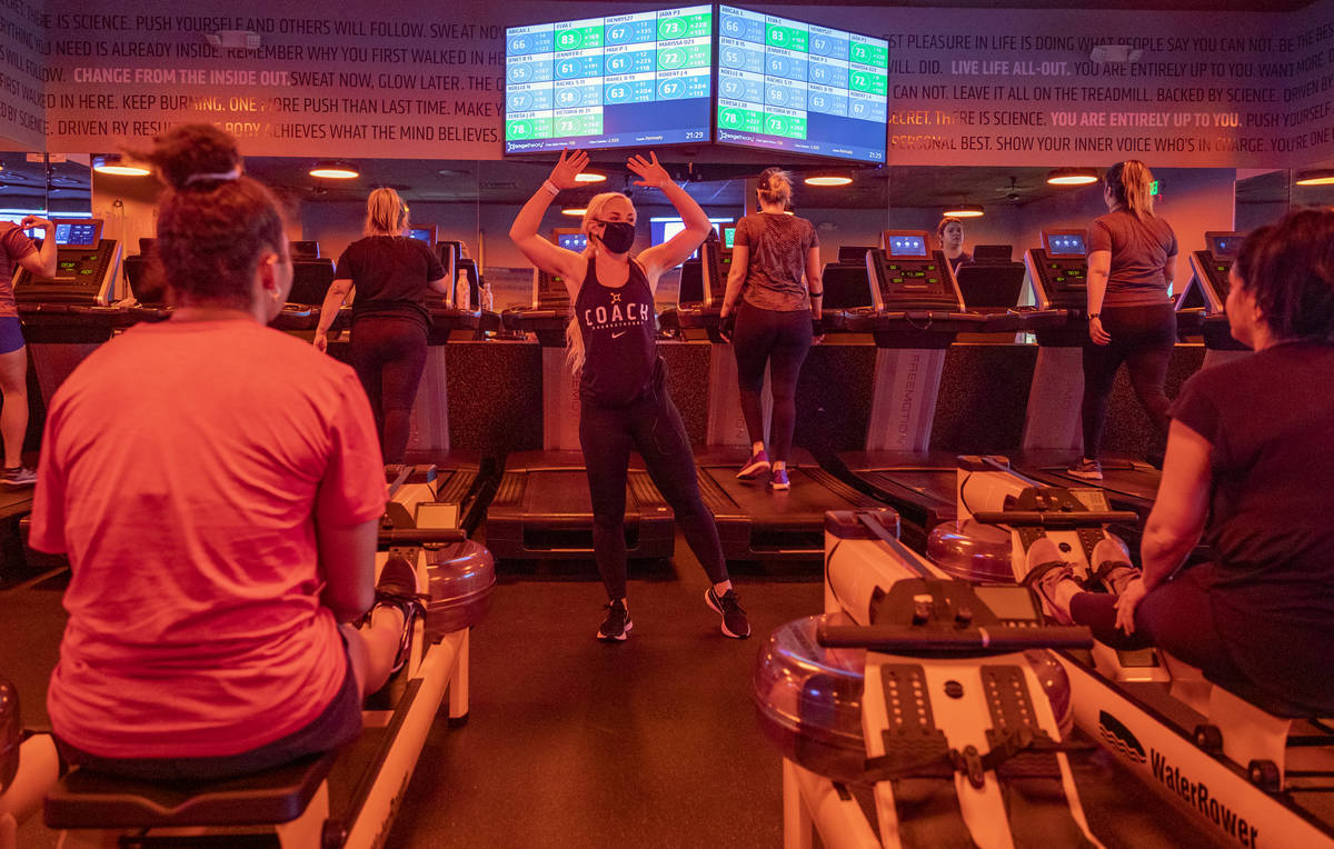 Orangetheory Fitness coach Kennady Whitehead instructs members while practicing social distanci ...