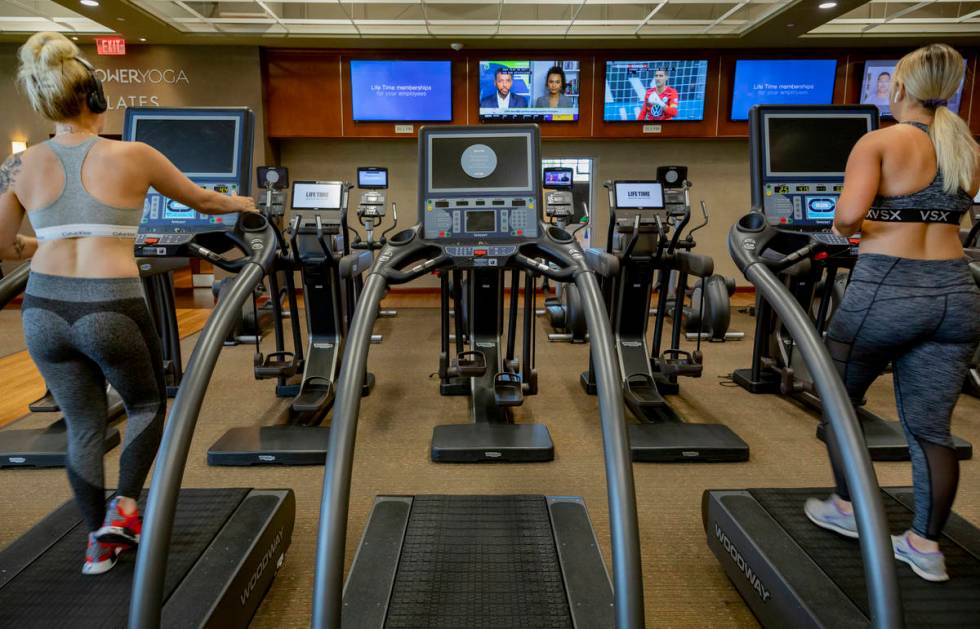 Life Time Fitness members practice social distancing while on treadmills at the Life Time Fitne ...