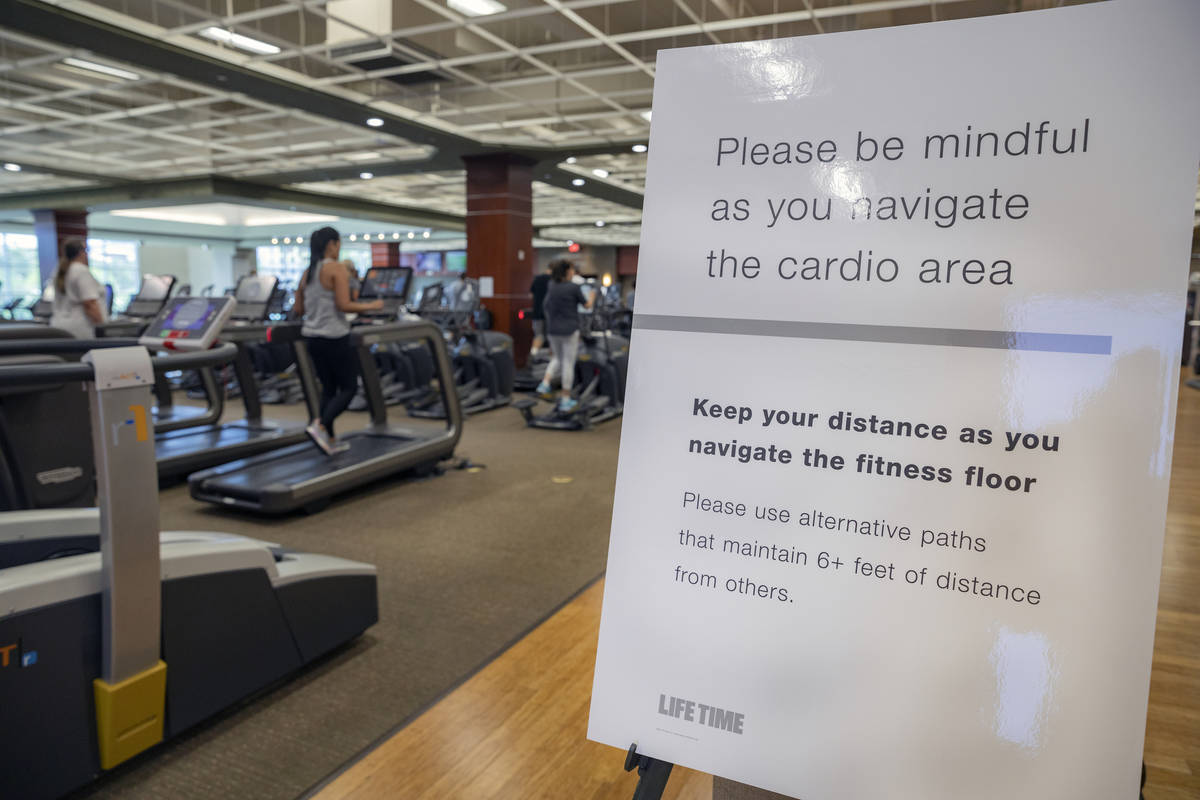 A social distancing sign is seen in the cardio area at Life Time Fitness located in Henderson o ...