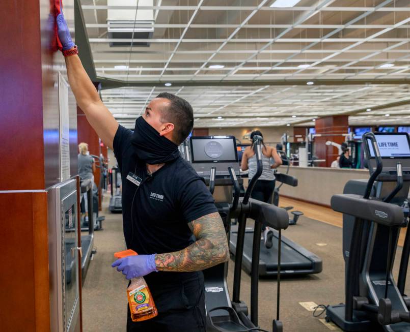 Life Time Fitness facility operations team member Jonathan Palmer deep cleans the Henderson loc ...