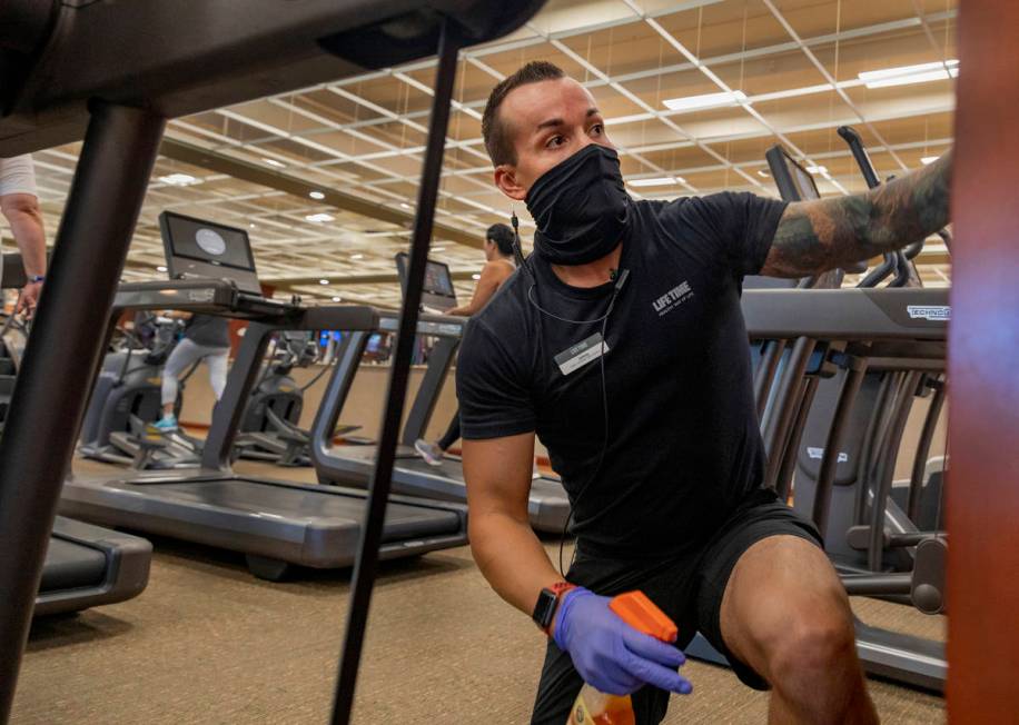 Life Time Fitness facility operations team member Jonathan Palmer deep cleans the Henderson loc ...