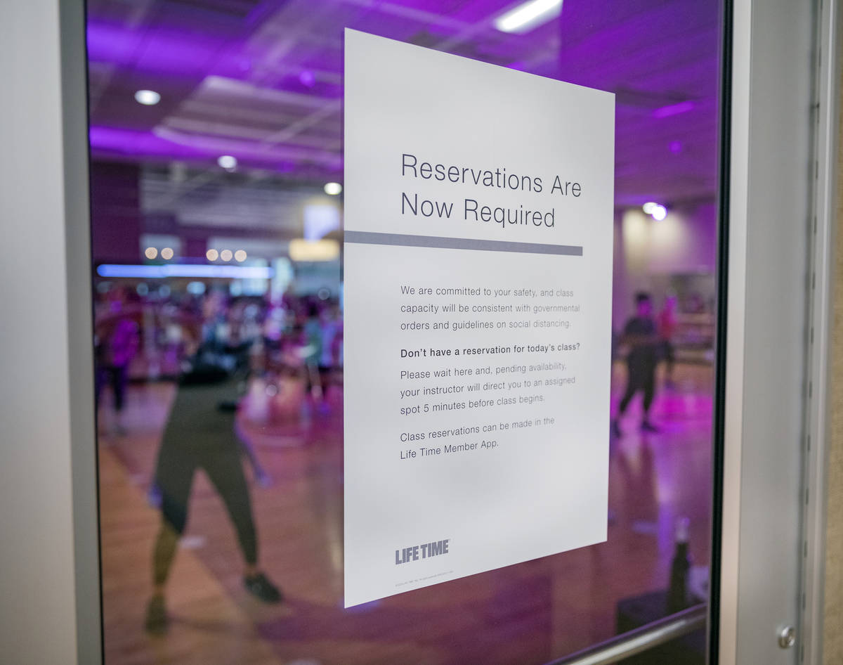 A sign stating the requirement of reservations for group fitness classes is seen at the Life Ti ...