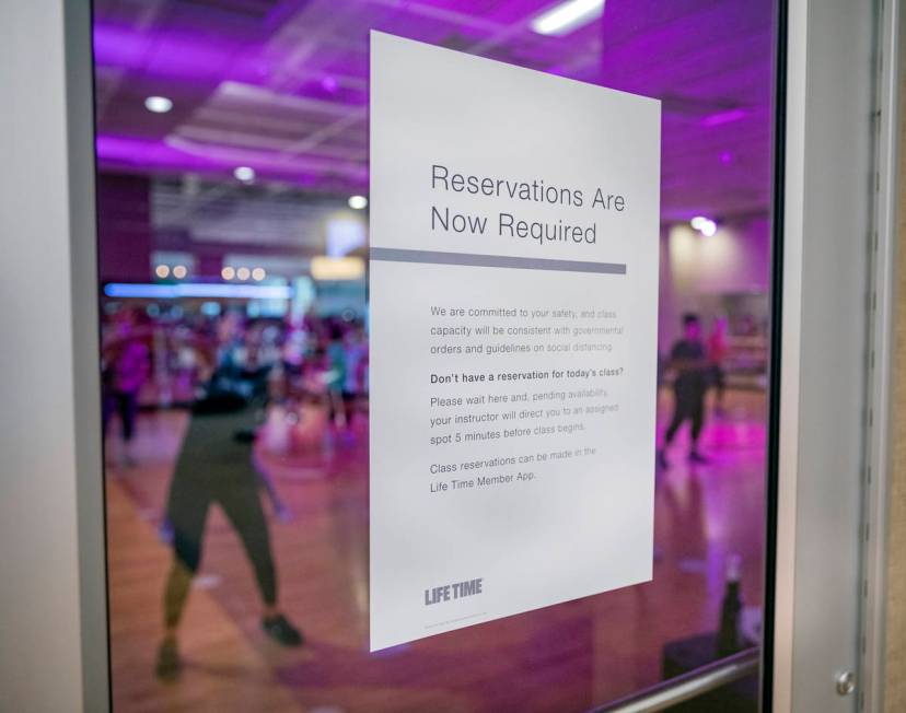 A sign stating the requirement of reservations for group fitness classes is seen at the Life Ti ...