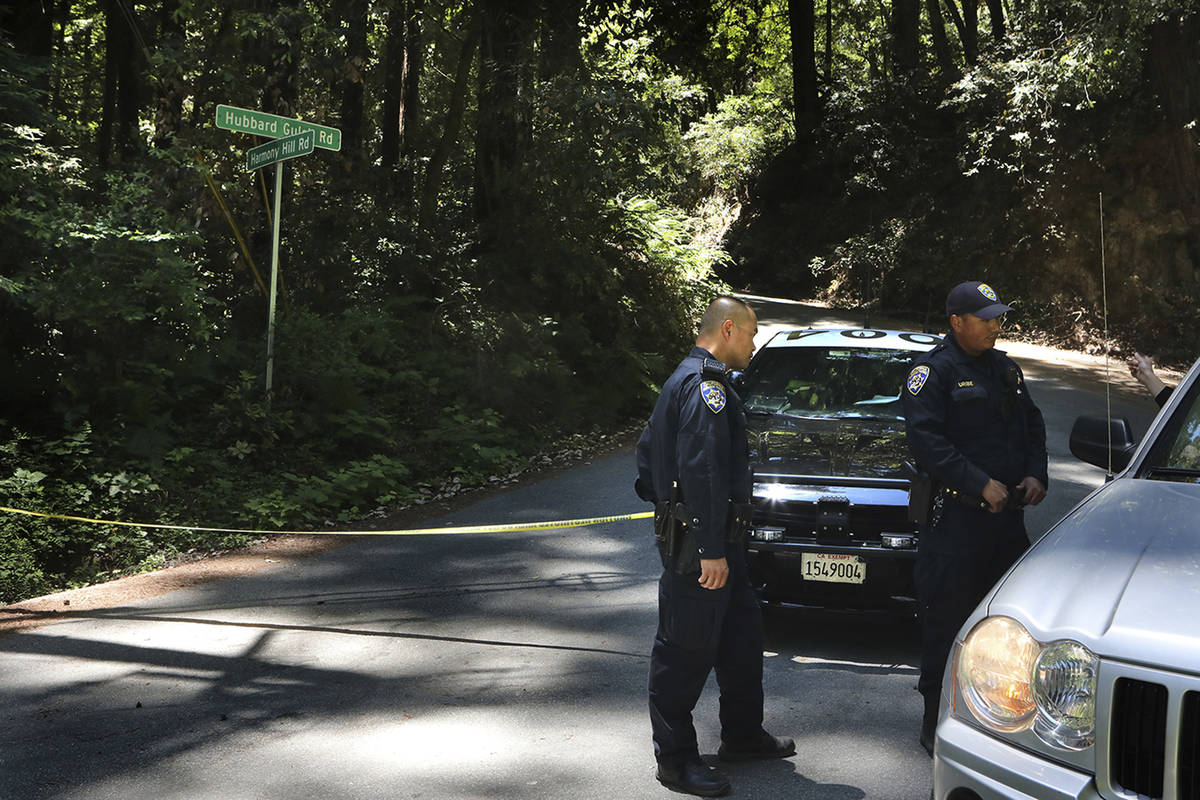 California Highway Patrol officers keep a road closed in Ben Lomond near Santa Cruz, Calif., Mo ...
