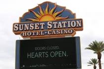 Sunset Station sign towers over an empty, blocked off parking lot after casinos were ordered cl ...