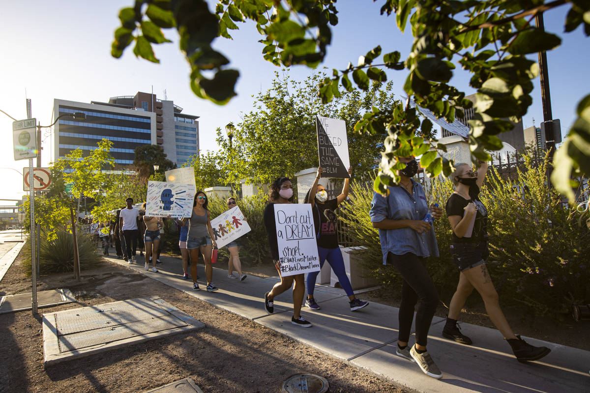 People participate in a Black Lives Matter protest outside in downtown Las Vegas on Wednesday, ...