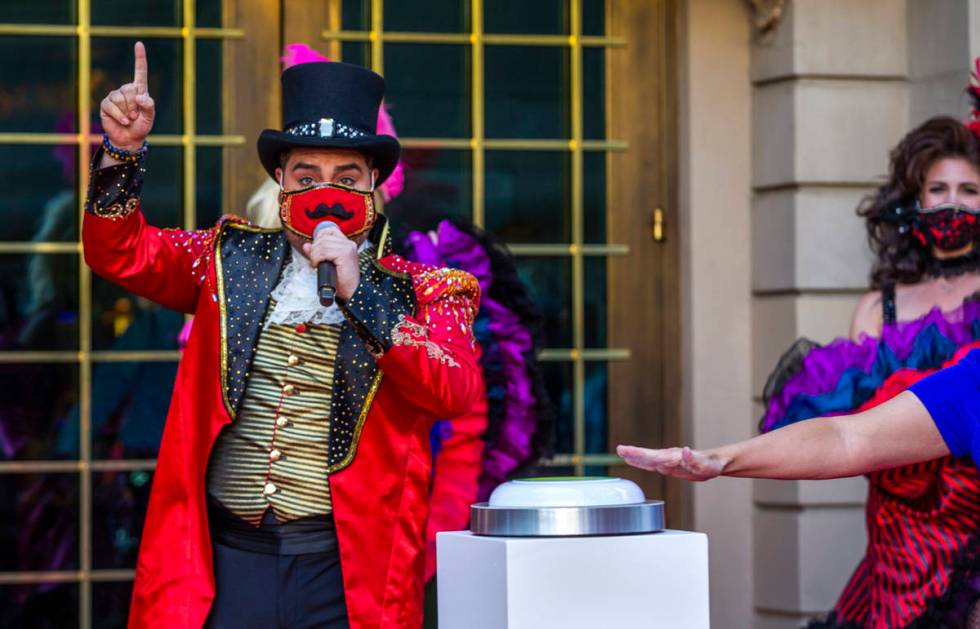 A Monsieur Loyal ringmaster counts down the final seconds outside the entrance of the Paris Las ...