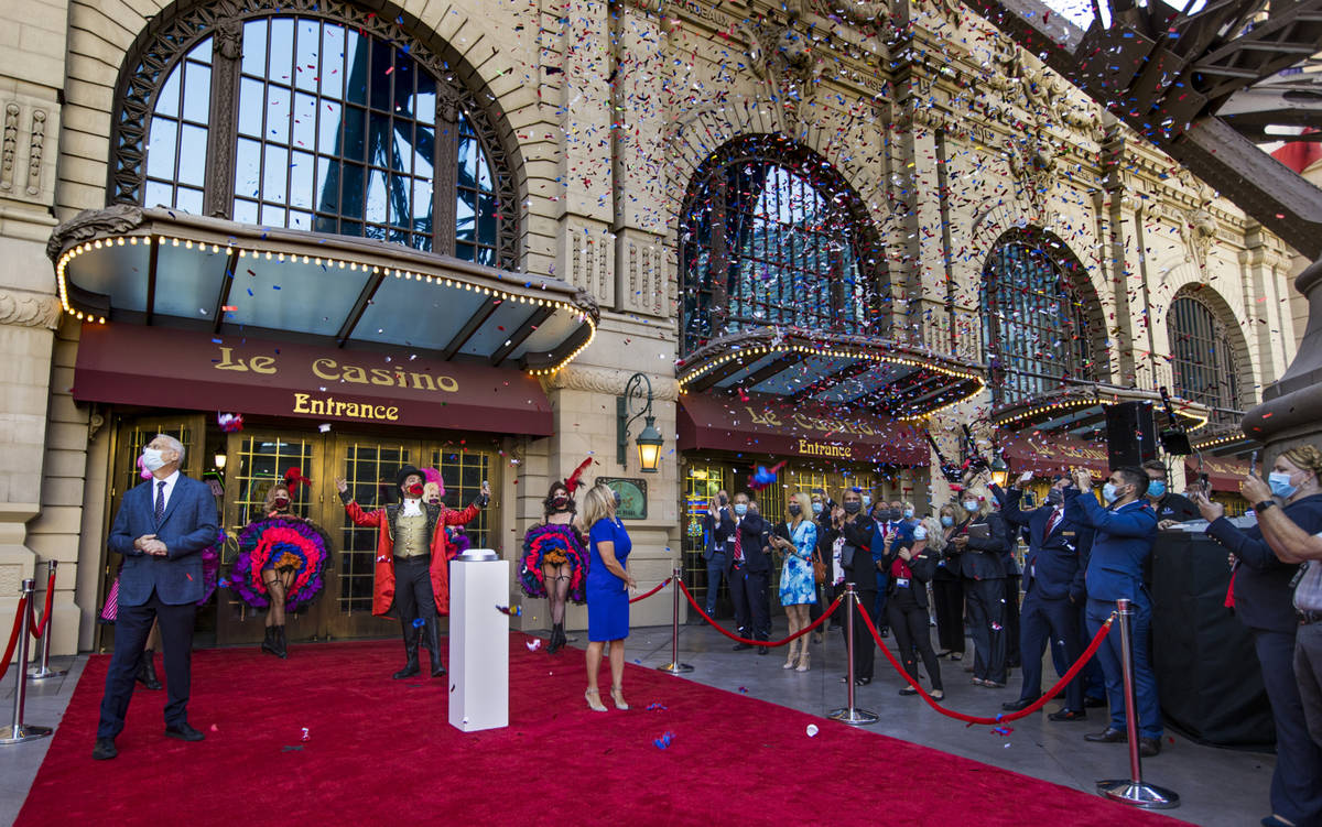 Blue, white and red confetti flutters over the entrance of the Paris Las Vegas during a reopeni ...