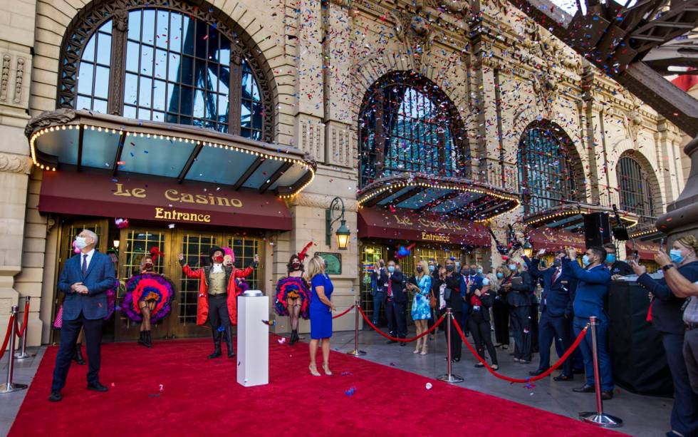 Blue, white and red confetti flutters over the entrance of the Paris Las Vegas during a reopeni ...