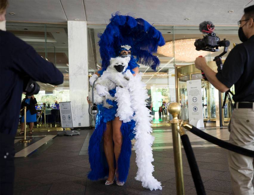 Jennifer Romas, from the Sexxy show, greets guests with the dog Sir Winston of Westgate at the ...