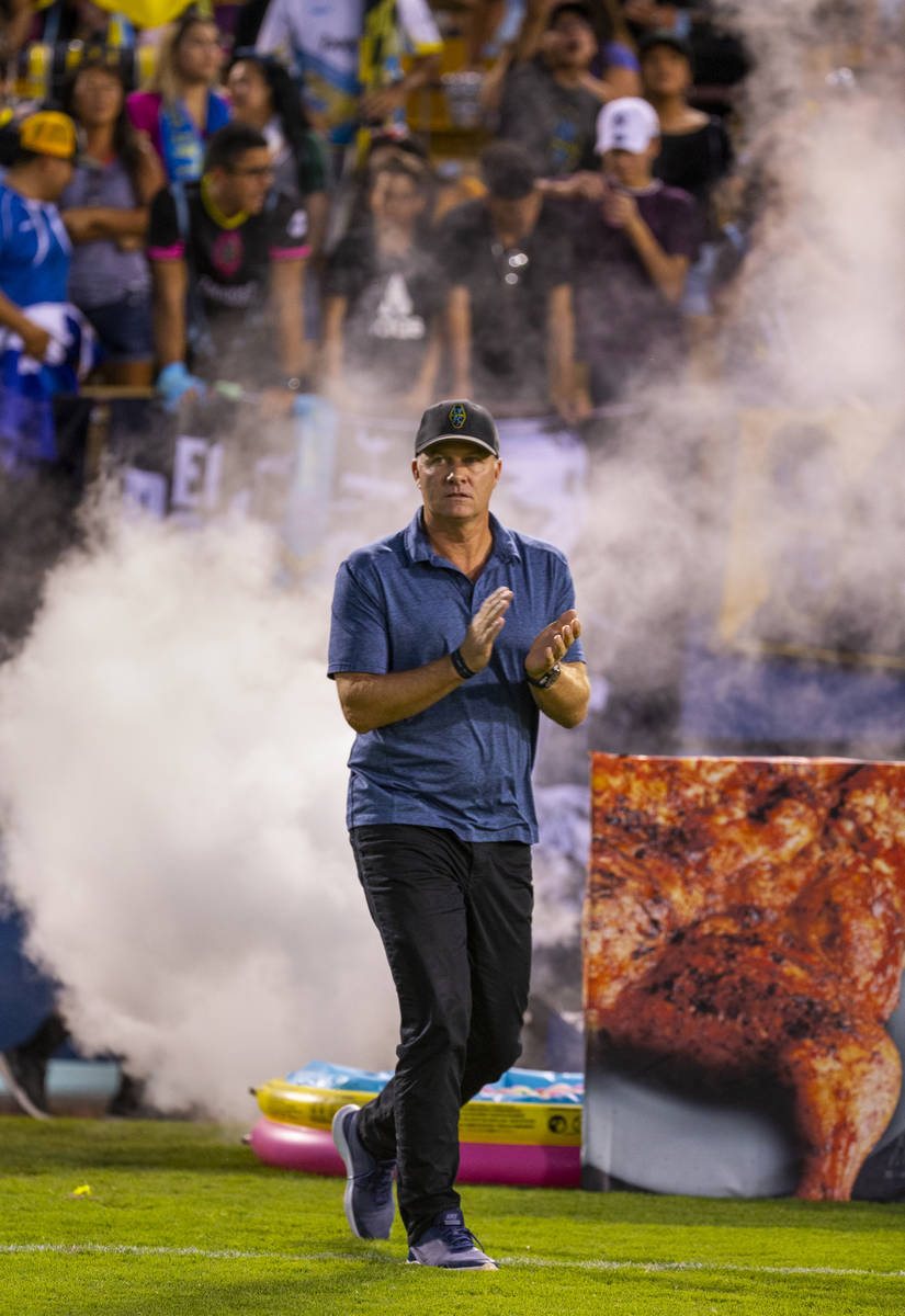 Las Vegas Lights FC head coach Eric Wynalda emerges from the smoke onto the field to face the P ...