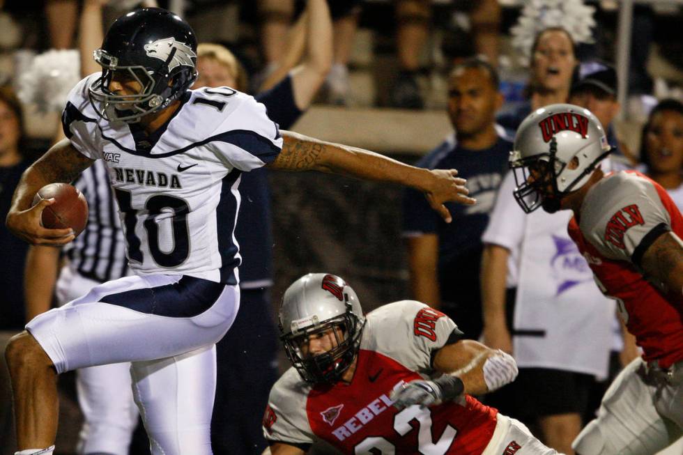 UNR quarterback Colin Kaepernick runs it through the UNLV defense for a touchdown during the fi ...