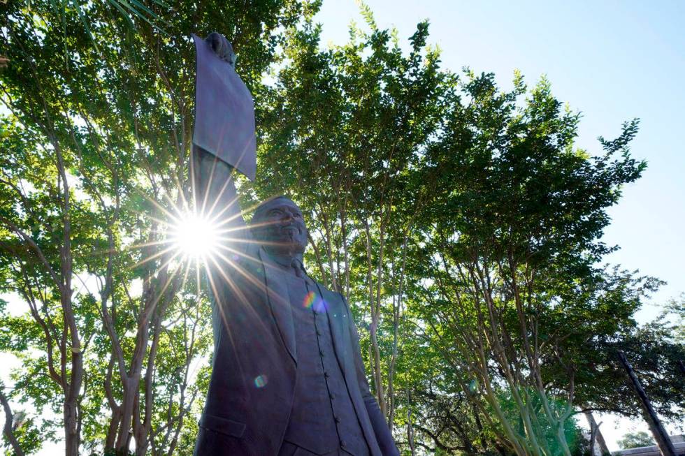 This statue depicts a man holding the state law that made Juneteenth a state holiday in Galvest ...