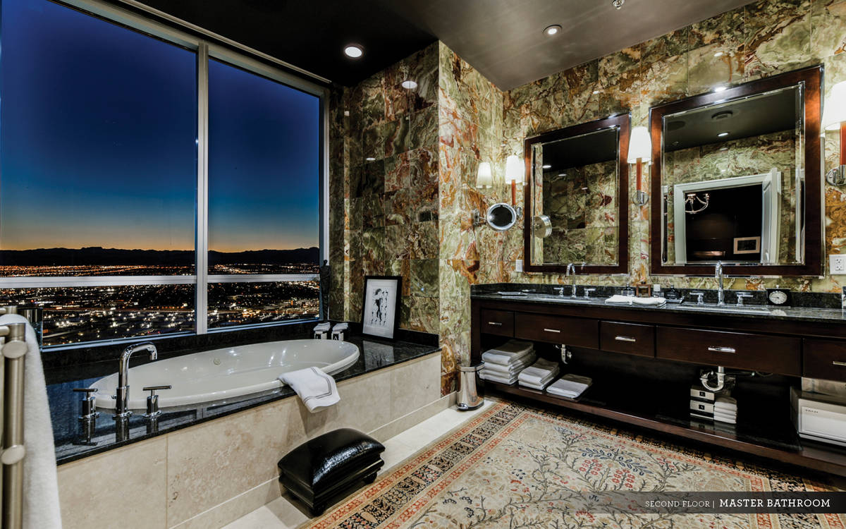 Ivan Sher Group The spa-like master bath showcases multicolored granite-esque stone walls, soak ...