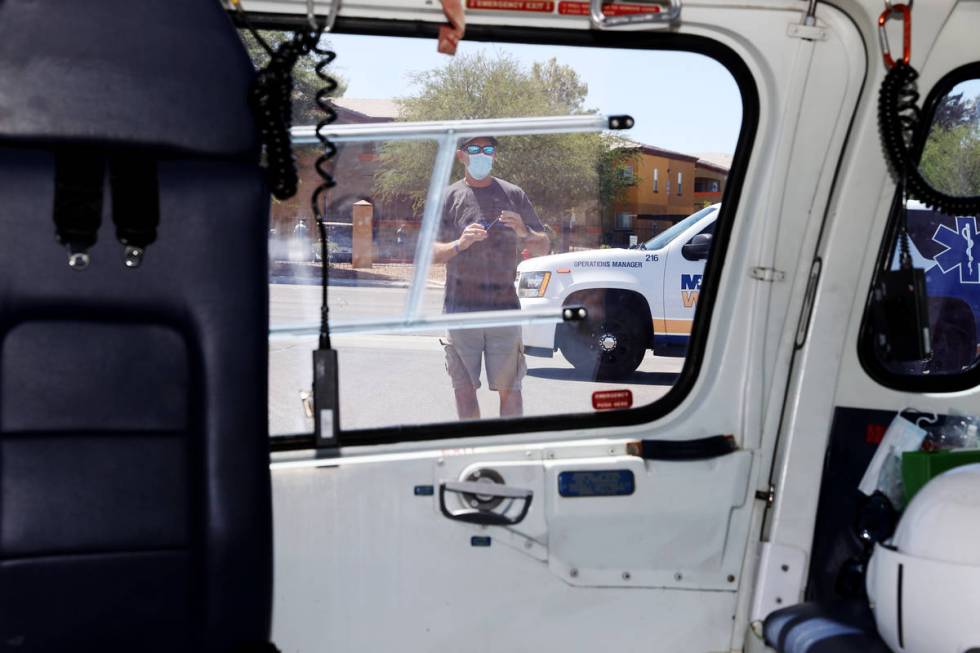 Patrick Neville, stepfather of wounded Las Vegas police officer Shay Mikalonis, stands in front ...