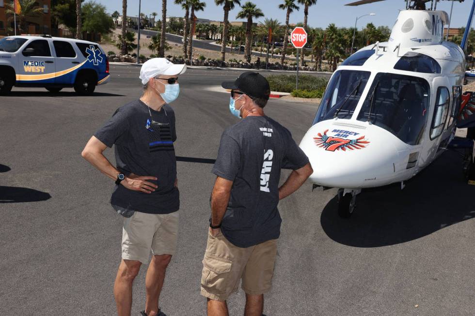 Frank Mikalonis, left, uncle of wounded Las Vegas police officer Shay Mikalonis, and Shay's ste ...