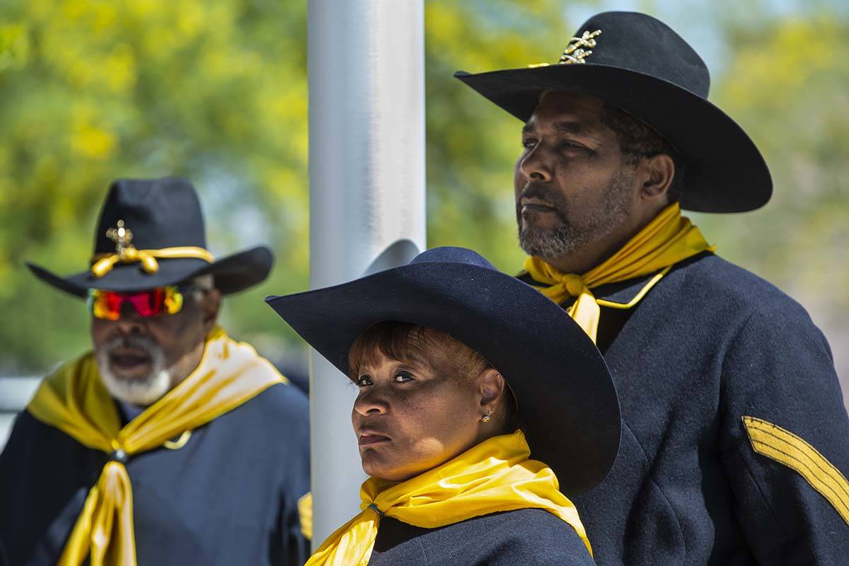 Buffalo Soldiers Jon Jon Everet, Kelly Hawthorne and Arby Hambrick stand together after raising ...