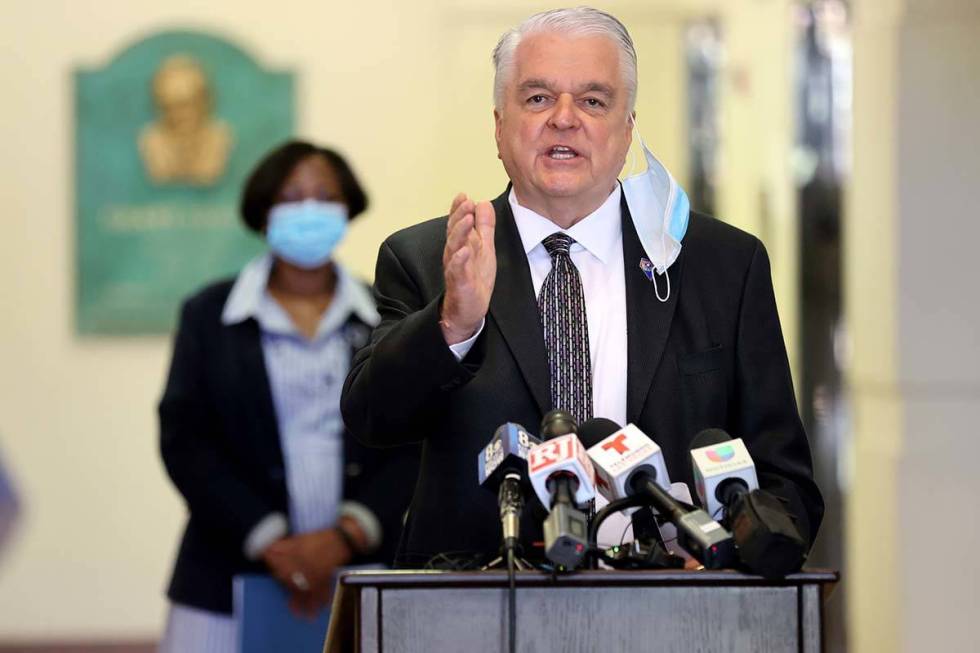 Gov. Steve Sisolak speaks as Assemblywoman Daniele Monroe-Moreno looks on during a press confer ...