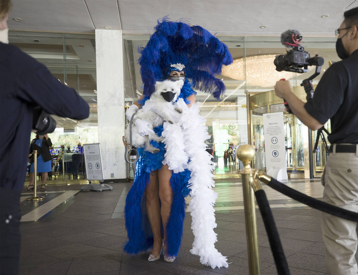 Jennifer Romas greets guests with the dog Sir Winston of Westgate at the reopening of the Westg ...