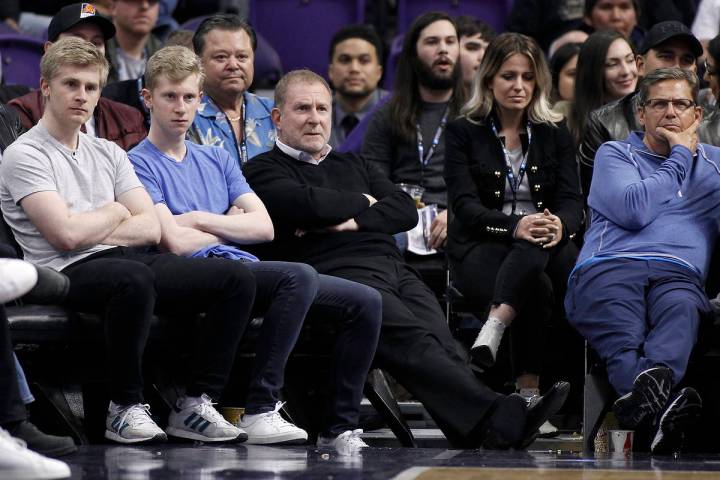 Phoenix Suns owner Robert Sarver, center, watches during the second half of an NBA basketball g ...