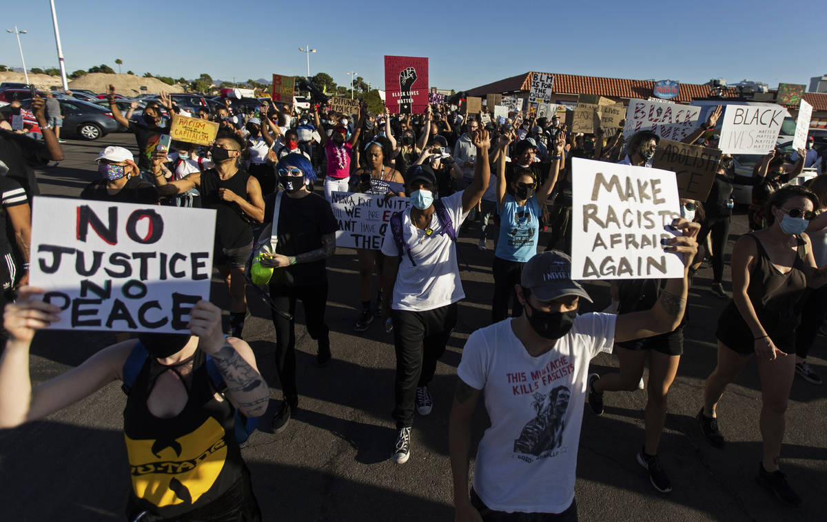 Protesters march on Sahara Avenue during a Juneteenth rally organized by Black Lives Matter on ...