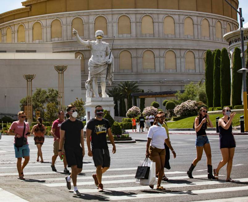 Pedestrians cross Las Vegas Boulevard in Las Vegas, Sunday, June 21, 2020. (Rachel Aston/Las Ve ...