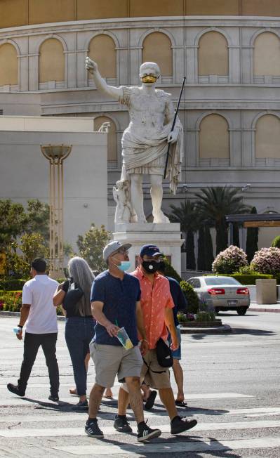 Pedestrians cross Las Vegas Boulevard in Las Vegas, Sunday, June 21, 2020. (Rachel Aston/Las Ve ...