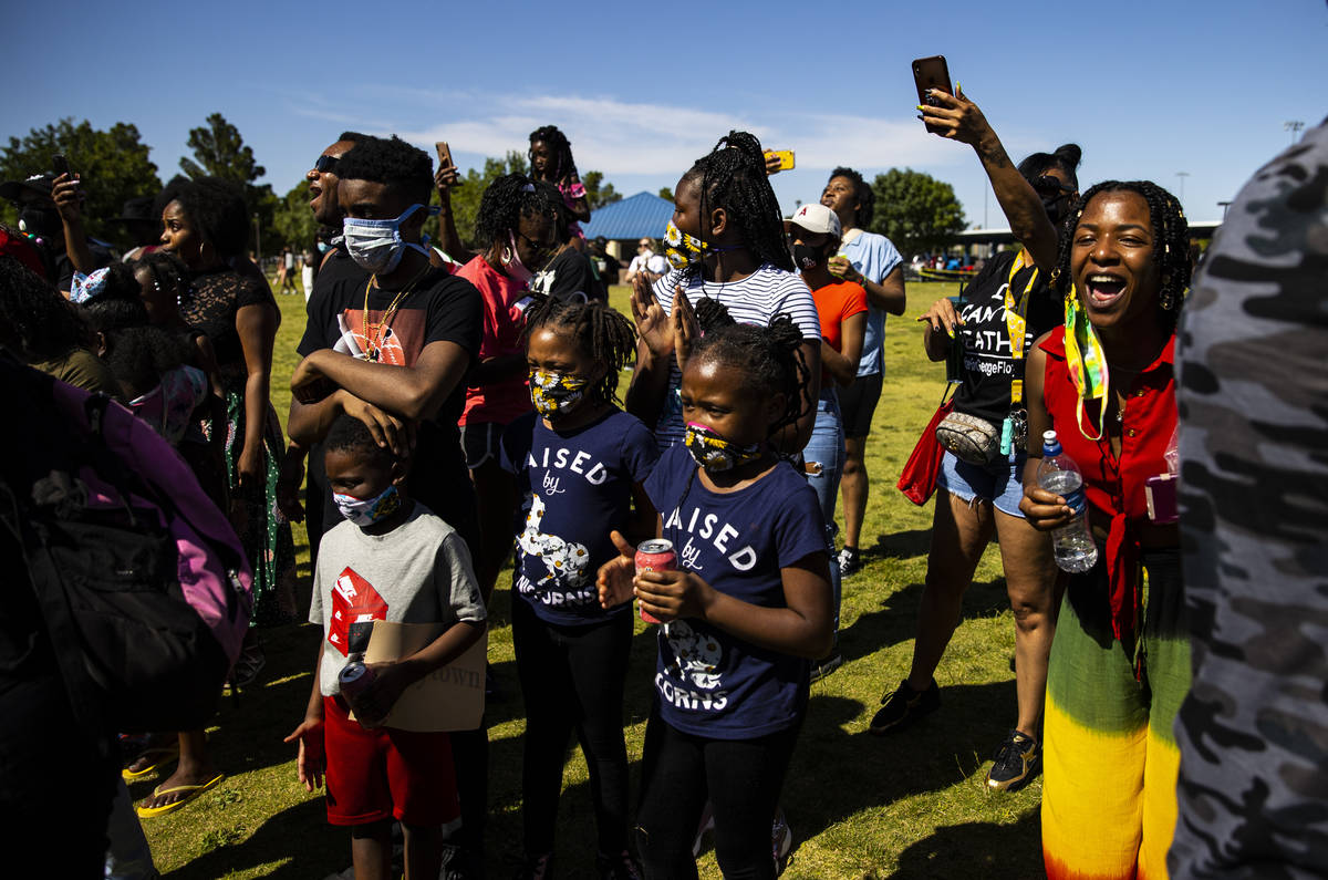 People gather during a Juneteenth event held by Save Our Sons at Lorenzi Park in Las Vegas on F ...