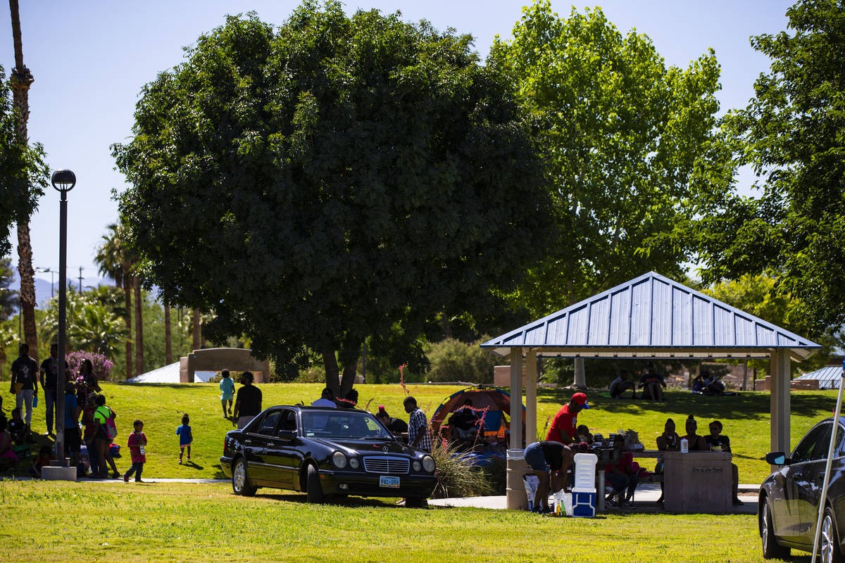 People gather and relax during a Juneteenth event held by Save Our Sons at Lorenzi Park in Las ...