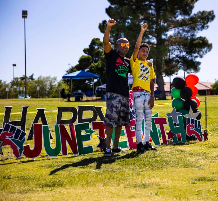 Marcus Webb, left, and Malachi Smith, 13, of Las Vegas, raises their fists while posing for a p ...