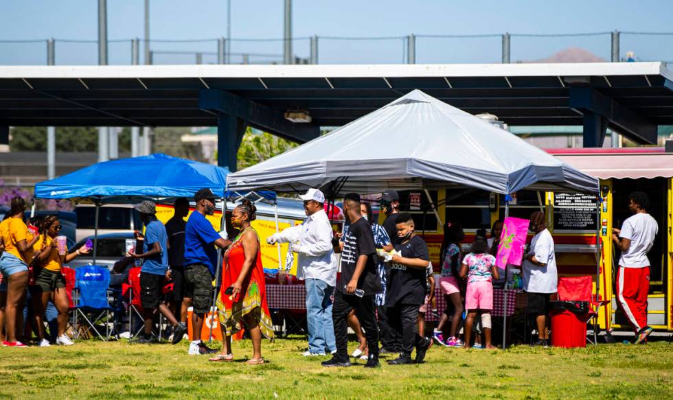 People check out vendors during a Juneteenth event held by Save Our Sons at Lorenzi Park in Las ...