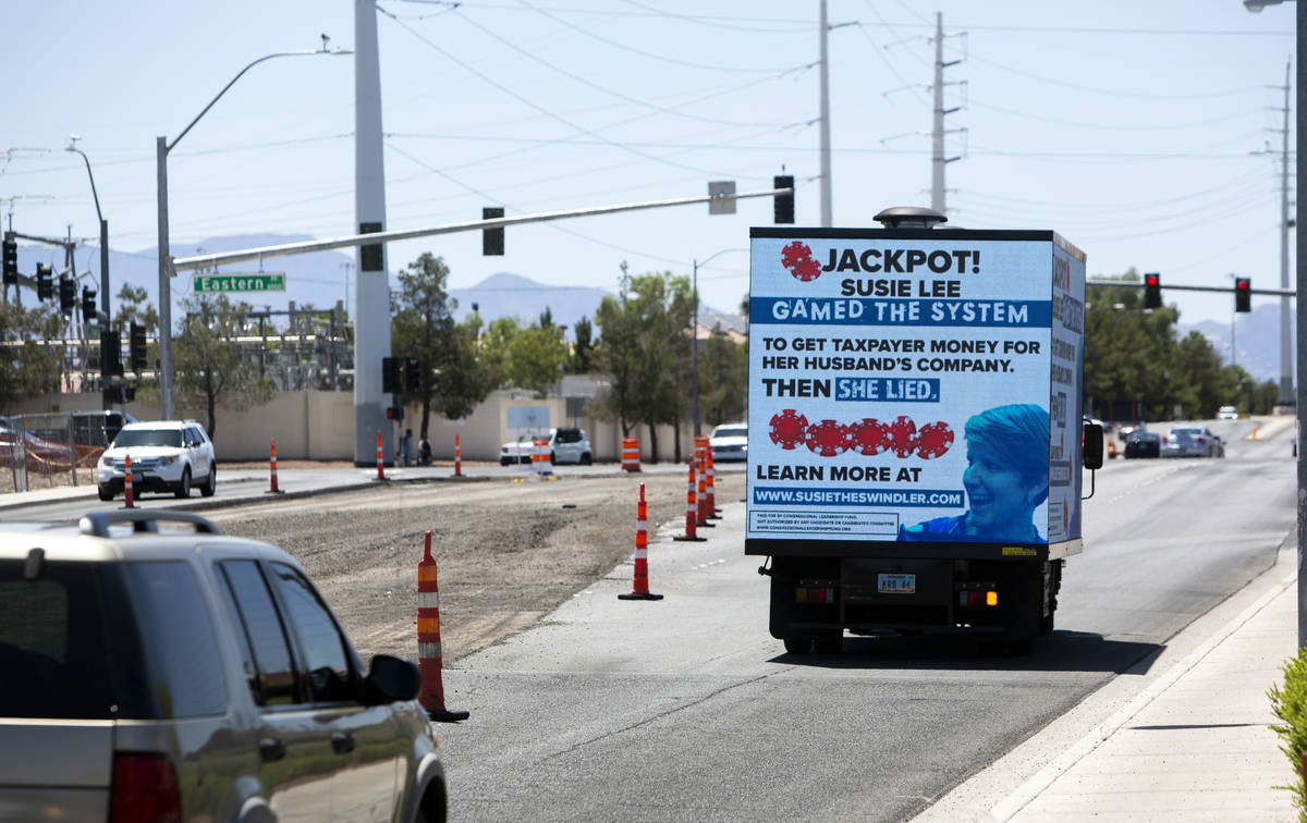 A mobile billboard attacking Rep. Susie Lee drives down Pebble Road next to Lee's office in Las ...