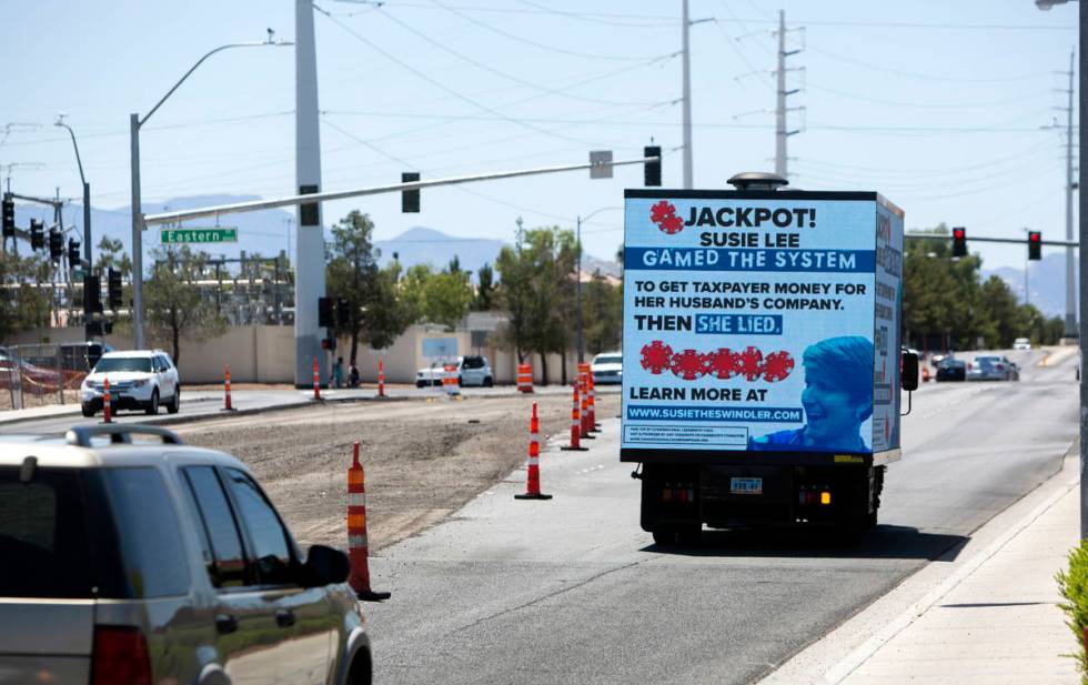 A mobile billboard attacking Rep. Susie Lee drives down Pebble Road next to Lee's office in Las ...