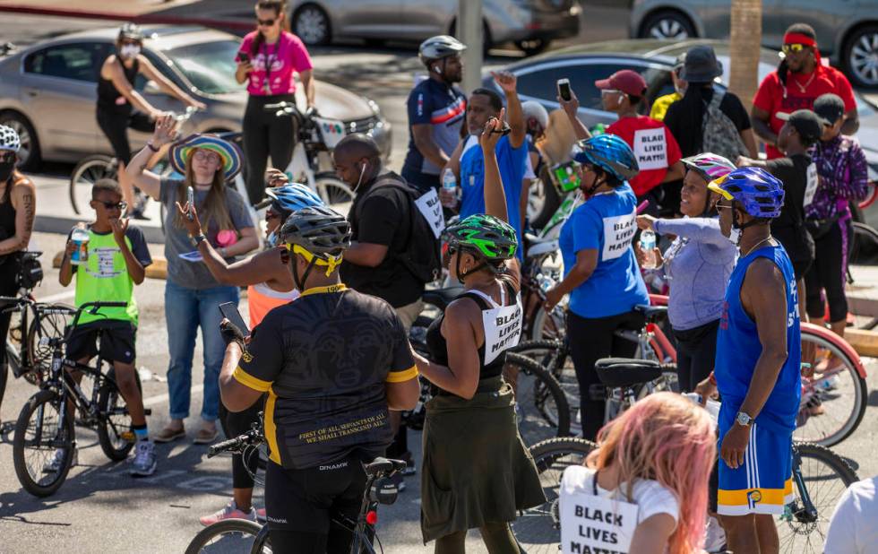 Participants in a Black Lives Matter bike ride against injustice cheer after returning to a par ...