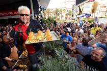 Guy Fieri serves hamburgers to guests during a welcome event for Guy Fieri's Vegas Kitchen & Ba ...