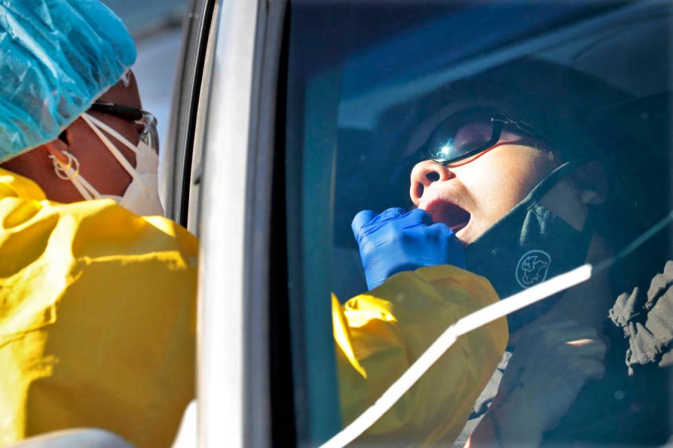 People get tested for COVID-19 at a drive through testing site hosted by the Puente Movement mi ...