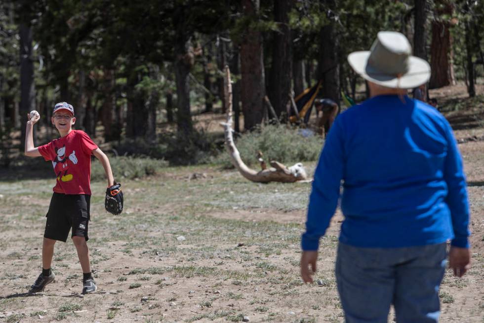 Landon Whitehead, 12, plays catch with his grandfather, Doug Whitehead, 61, at Lee Canyon on Mo ...