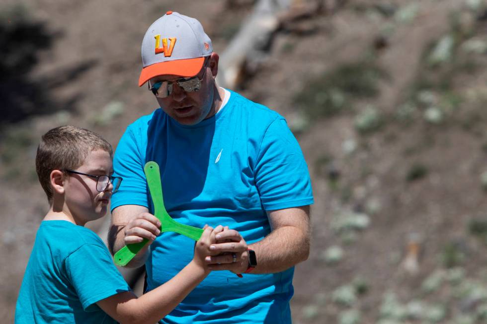 Jeff Whitehead teaches his son, Garrett Whitehead, 8, how to throw a boomerang at Lee Canyon on ...