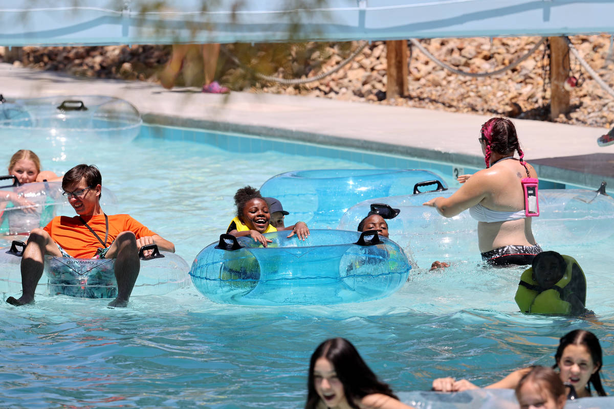 People ride the Lazy River on opening day at Wet 'n' Wild water park in Las Vegas Monday, June ...