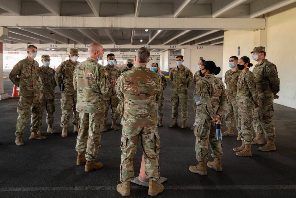 Nevada National Guardsmen take part in a preview of the new drive-thru COVID-19 testing site in ...