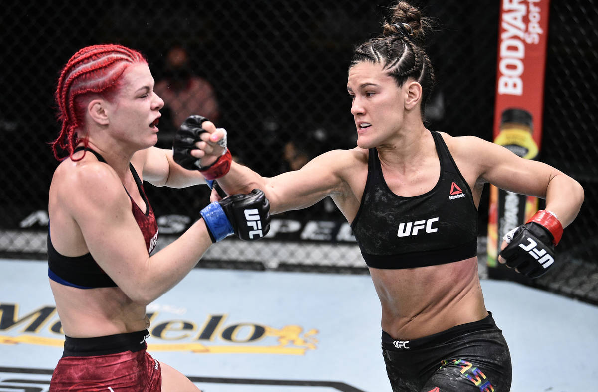 Cortney Casey punches Gillian Robertson of Canada in their flyweight bout during the UFC Fight ...