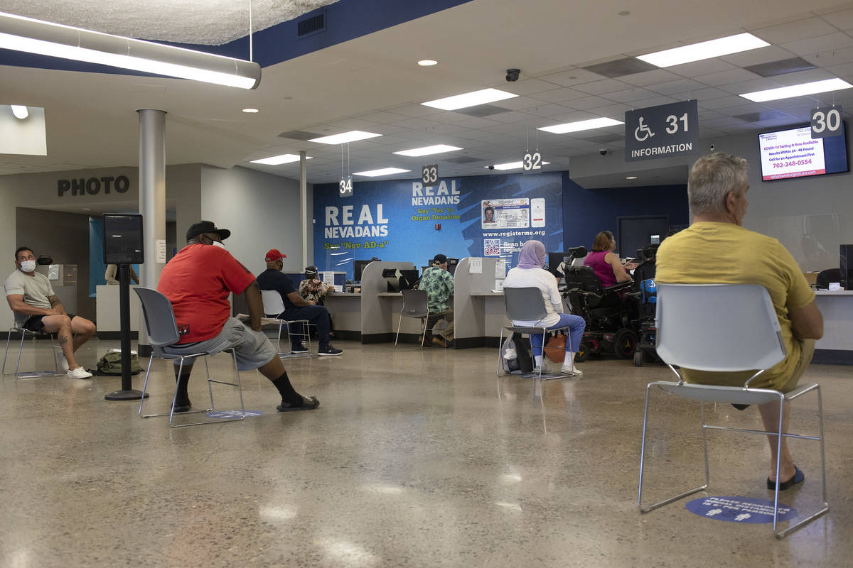 People near the finish line after long wait times at the Nevada Department of Motor Vehicles at ...