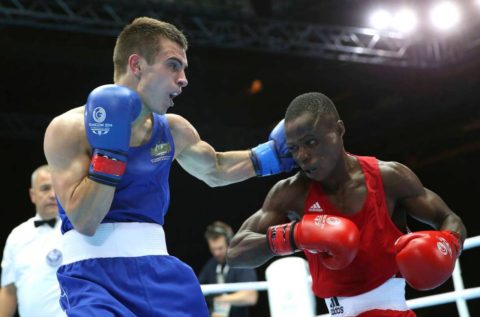 Australia's Andrew Moloney, left, lands a left hook on Nigeria's Wasiu Taiwo during their men's ...