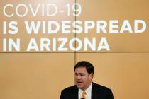 Arizona Republican Gov. Doug Ducey speaks about the latest coronavirus data at a news conferenc ...