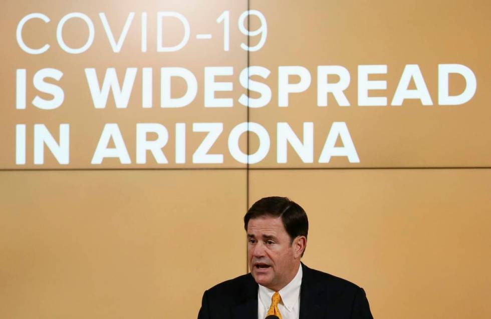 Arizona Republican Gov. Doug Ducey speaks about the latest coronavirus data at a news conferenc ...